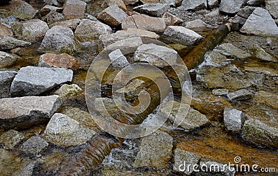 Regulation of poor water flow of the stream when it is necessary to slow down the flow of water in front of the bridge using beams Stock Photo