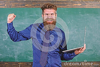 Pass test online. Distance education concept. Hipster teacher eyeglasses holds laptop passed distance knowledge check Stock Photo