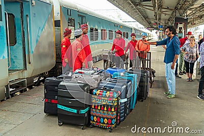 Tour guide directing porters at a Chandigarh Station Editorial Stock Photo
