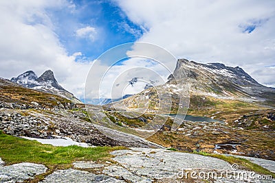 Passage in the mountains with snowy peaks around Alnesvatnet lake panorama, path of trolles, Trollstigen, Rauma Municipality, More Stock Photo