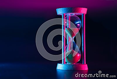 Passage of time. Hourglass on a dark background. Stock Photo