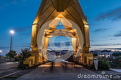 Passage under the yellow crane titan by night in Nantes Stock Photo