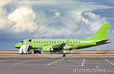 Passenger airliner at the airport during maintenance by technicians. Preflight preparation. Photography. Stock Photo