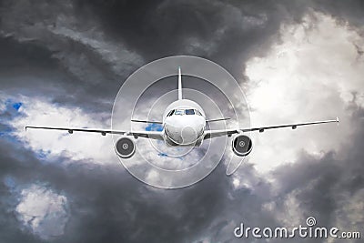 Passenger airplane flies through the turbulence zone through the lightning of storm clouds in bad weather. Stock Photo