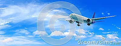 Passenger airplane flying above clouds. View from the window plane to amazing sky with beautiful clouds. Stock Photo