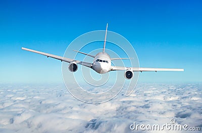 Passenger airplane flying at flight level high in the sky above the clouds. View directly in front, exactly. Stock Photo