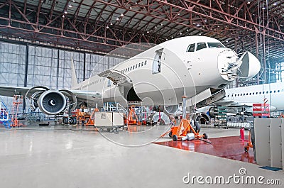 Passenger airplane on maintenance of engine and fuselage repair Stock Photo