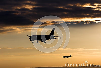 Passenger airplanes landing in the evening sun Stock Photo