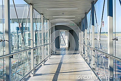 Passenger boarding bridge PBB to board airplane. Boarding gate entrance to train station from via skybridge Stock Photo