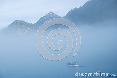 Passenger boat misty day on the Koenigssee Stock Photo