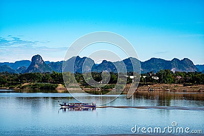 Passenger boats are ferrying between Thailand and Laos on the Mekong River. in Nakhon Phanom and Khammouane Province Editorial Stock Photo
