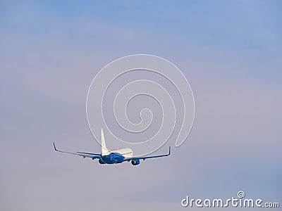 Passenger commercial airplane flying against the sky Stock Photo
