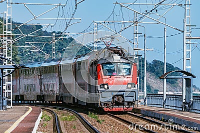 Passenger double deck train moves along the mountains. Sochi Stock Photo