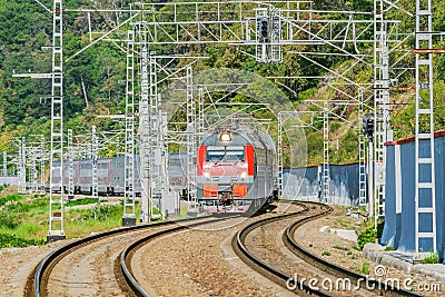 Passenger double deck train moves along the mountains. Sochi Stock Photo