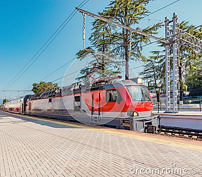 Passenger double deck train is ready to depart from the main railway station. Sochi Stock Photo