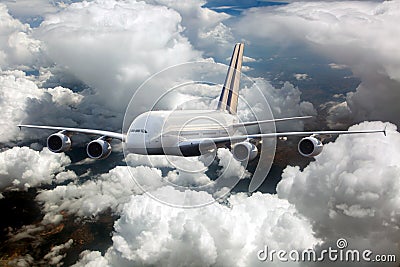 Passenger double decker plane fly high in the cloudy sky. Front view Stock Photo