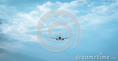 Passenger jet flying into breathtaking cloudly horizon Stock Photo