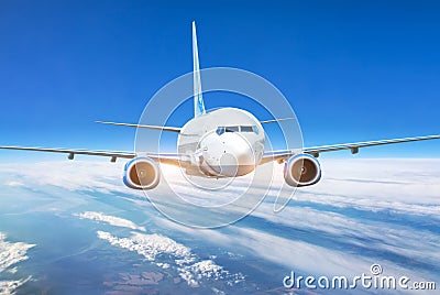 Passenger jet plane in the blue sky. Aircraft flying high through the cumulus clouds. Close up view airplane in flight Stock Photo