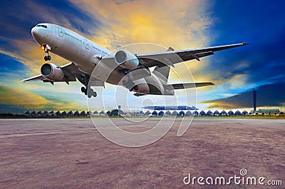 passenger jet plane landing on air port runways against beautiful dusky sky use for travel business and air transport Stock Photo