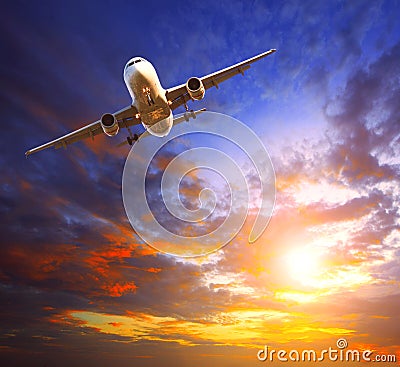 Passenger jet plane preparing to landing against beautiful dusky Stock Photo