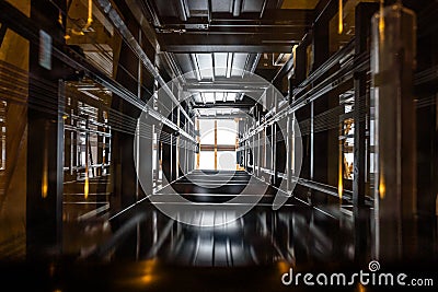 The passenger lift shaft seen from the glass cabin, a glazed roof at the top. Stock Photo