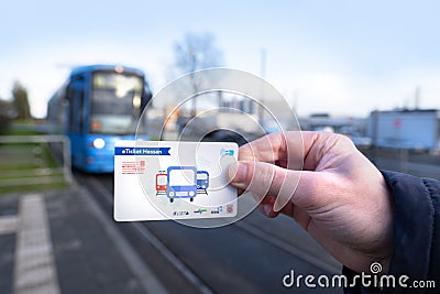 passenger, male hand hold electronic ticket, travel eTicket passes for public transport, Stadtbahn train, typical German Public Editorial Stock Photo