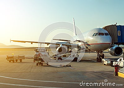 Passenger plane in the airport at sunrise. Stock Photo