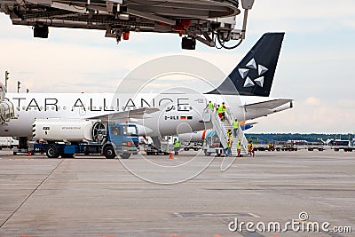 Passenger plane German airline STAR ALLIANS Airbus A-319 D-AILS. Airport apron workers. Maintenance refueling and Editorial Stock Photo