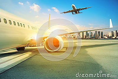 passenger plane parking at airport terminal and other approach for landing to runway Stock Photo