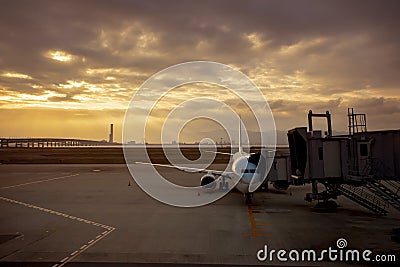 Passenger plane preparing for departure from airport terminal early morning Stock Photo