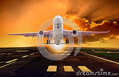 Passenger plane take off from runways against beautiful dusky sk Stock Photo