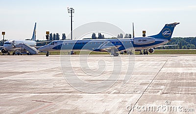 Passenger plane UR-DNR WINDROSE AIRLINES EMBRAER ERJ-145 on the platform of Boryspil International Airport. Runway. Kyiv Editorial Stock Photo