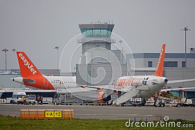 Passenger planes and airport control tower Editorial Stock Photo