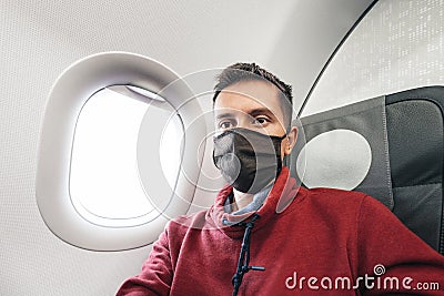 Passenger in protective medical mask are waiting for the plane to take off. Covid pandemic and spreading of desease by Stock Photo