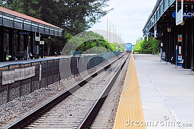 Passenger train leaves station Stock Photo