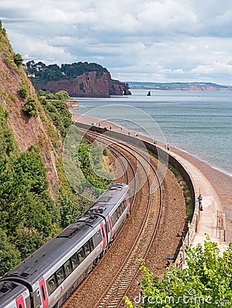 Passenger train leaving Teignmouth on the coastal line heading towards Dawlish Editorial Stock Photo