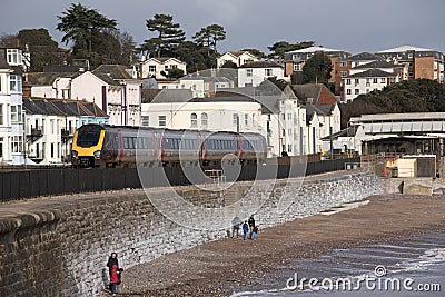 Passenger train passing Dawlish a seaside town in Devon England UK Editorial Stock Photo