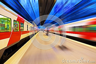 Passenger train passing railway station Stock Photo