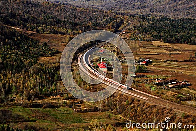 A passenger train running through the immense froest(II) Stock Photo