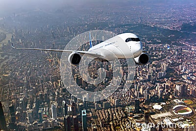 Passenger wide-body plane flies above the skyscrapers of the business center of the big city. Front view of Stock Photo