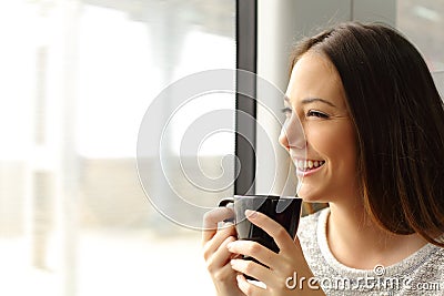 Passenger woman drinking coffee during a train travel Stock Photo