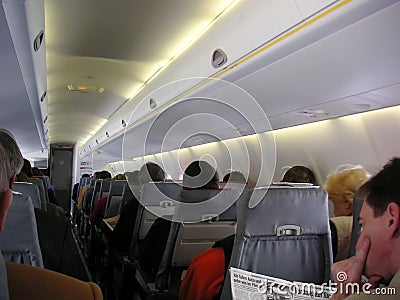 Passengers in Airplane cabin Stock Photo