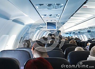 Passengers in airplane cabin interior Editorial Stock Photo