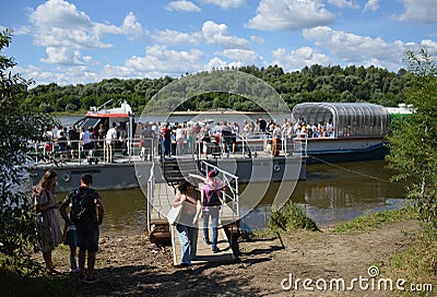 Passengers arriving by a riverboat on the river Oka Editorial Stock Photo