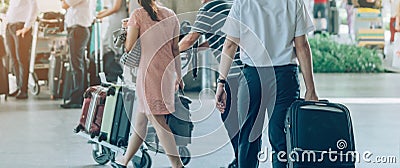 Passengers with big roller luggage stand to wait for the car to pick up Editorial Stock Photo