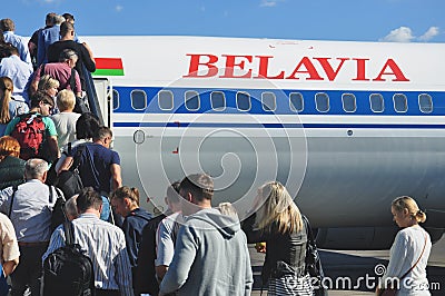 Passengers boarding airplane Editorial Stock Photo