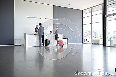 Passengers checkout at hotel reception Stock Photo