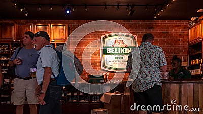 Passengers enjoying Belikin Beer while waiting for their flights out of Philip S. W. Goldson Airport in Belize City, Belize Editorial Stock Photo