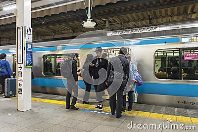Passengers entering train Tokyo station Editorial Stock Photo