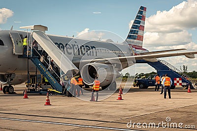 Passengers get off American Airlines airplane at Belize City, Belize Editorial Stock Photo